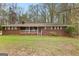 Charming brick ranch-style home featuring a lovely front porch and a spacious, well-manicured lawn at 1407 Highway 92 N, Fayetteville, GA 30214