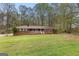 Charming brick ranch-style home featuring a lovely front porch and a spacious, well-manicured lawn at 1407 Highway 92 N, Fayetteville, GA 30214