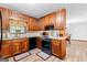 Well-lit kitchen featuring wood cabinets, granite countertops and modern black appliances at 1407 Highway 92 N, Fayetteville, GA 30214