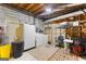 Basement laundry area with washer, dryer, storage cabinet, and concrete flooring at 1407 Highway 92 N, Fayetteville, GA 30214