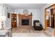 Cozy living room featuring a brick fireplace and an inviting, comfortable leather armchair at 1407 Highway 92 N, Fayetteville, GA 30214