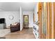 Open-concept living area with hardwood floors, a comfortable leather sofa, and lots of natural light at 1407 Highway 92 N, Fayetteville, GA 30214
