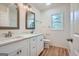 Bright bathroom featuring double sinks, large mirrors, and modern fixtures at 2069 Sandtown Sw Rd, Atlanta, GA 30311