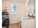 Updated bathroom featuring a vanity with granite countertop, modern fixtures and a front-loading washer/dryer combo at 2069 Sandtown Sw Rd, Atlanta, GA 30311