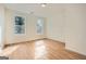Bright bedroom featuring hardwood floors, two windows offering natural light, and neutral walls at 2069 Sandtown Sw Rd, Atlanta, GA 30311