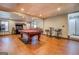 Basement game room with pool table, entertainment center, and ample seating at 1744 Elks Club Rd, Covington, GA 30014