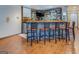 Basement bar with seating, a TV, and a mix of modern and rustic design elements at 1744 Elks Club Rd, Covington, GA 30014
