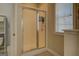 Walk-in shower with a semi-opaque glass door provides privacy and natural light from the window at 1744 Elks Club Rd, Covington, GA 30014
