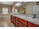 Bathroom features a double vanity with neutral countertops and abundant storage space beneath at 1744 Elks Club Rd, Covington, GA 30014
