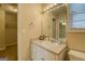 Bathroom with large mirror, vanity, and view to bedroom and closet areas at 1744 Elks Club Rd, Covington, GA 30014