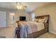 Comfortable bedroom with ceiling fan and television with attached bathroom at 1744 Elks Club Rd, Covington, GA 30014
