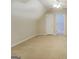 Bright bedroom with neutral carpeting and attached room access at 1744 Elks Club Rd, Covington, GA 30014