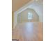 Spacious bedroom featuring light hardwood floors and a bright window allowing natural light at 1744 Elks Club Rd, Covington, GA 30014