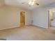 Large, well-lit bedroom offering ceiling fan and views of the bathroom and room entrances at 1744 Elks Club Rd, Covington, GA 30014