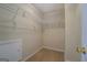 Walk-in closet with wire shelving and carpeted floor, offering plenty of storage space at 1744 Elks Club Rd, Covington, GA 30014
