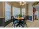 Cozy dining area with a round wooden table, black chairs, and bright natural light at 1744 Elks Club Rd, Covington, GA 30014