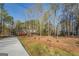 Well maintained brick home surrounded by trees, featuring a long driveway and manicured grounds at 1744 Elks Club Rd, Covington, GA 30014