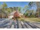Brick home with an attached garage, long driveway, and well-manicured lawn and landscaping at 1744 Elks Club Rd, Covington, GA 30014