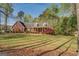 Charming brick home featuring a spacious front yard with mature trees and a welcoming covered porch at 1744 Elks Club Rd, Covington, GA 30014