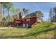 A view of the house featuring a brick exterior, deck, and well-maintained lawn at 1744 Elks Club Rd, Covington, GA 30014