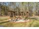 Cozy fire pit area with a pergola, seating, and a brick-lined perimeter at 1744 Elks Club Rd, Covington, GA 30014