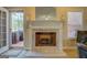 Close-up view of a marble fireplace, neutral carpet, and access to backyard and natural light at 1744 Elks Club Rd, Covington, GA 30014