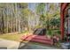 Outdoor hot tub on a wooden deck surrounded by lush landscaping at 1744 Elks Club Rd, Covington, GA 30014