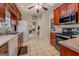 Spacious kitchen with wood cabinets, tile flooring, and access to a living area at 1744 Elks Club Rd, Covington, GA 30014