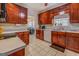 The kitchen features updated wood cabinets, light countertops, modern appliances, and tile flooring at 1744 Elks Club Rd, Covington, GA 30014