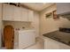 Laundry room with tiled floor, ample cabinetry, counter, and a chest freezer at 1744 Elks Club Rd, Covington, GA 30014
