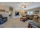 Comfortable living room with plush seating, media center, neutral carpet, and access to other rooms at 1744 Elks Club Rd, Covington, GA 30014