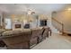 Inviting living room with plush furniture, fireplace, neutral carpet, and stairway access at 1744 Elks Club Rd, Covington, GA 30014