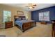 Comfortable bedroom with a large bed, nightstands, and ample natural light from large windows at 1744 Elks Club Rd, Covington, GA 30014