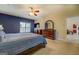 Spacious main bedroom with blue accent wall, windows and ample space at 1744 Elks Club Rd, Covington, GA 30014