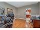 Well-lit office area featuring wood floors, desk, and a neutral color scheme at 1744 Elks Club Rd, Covington, GA 30014