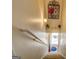 Bright staircase with carpet and railing leads to a blue welcome mat and sunlit entrance at 1744 Elks Club Rd, Covington, GA 30014