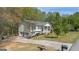 Beautiful home with a two-car garage, an inviting front porch, and a well-manicured lawn at 319 Honeysuckle Ter, Auburn, GA 30011