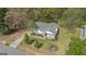 Aerial view of home with lush green landscaping and a charming front porch at 319 Honeysuckle Ter, Auburn, GA 30011