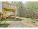 A backyard deck in a yard with mature trees offering shade and a place to relax at 319 Honeysuckle Ter, Auburn, GA 30011