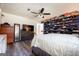 Bedroom featuring wood floors, ceiling fan, a closet with shelving and wall-mounted TV at 319 Honeysuckle Ter, Auburn, GA 30011