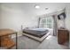 Bright bedroom with a large window, plush carpet, and neutral walls at 319 Honeysuckle Ter, Auburn, GA 30011