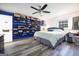 Unique bedroom with custom closet shelving, ceiling fan, and wood-look floors at 319 Honeysuckle Ter, Auburn, GA 30011