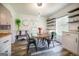 Well-lit dining area with seating for six and a view of the backyard; hardwood floors at 319 Honeysuckle Ter, Auburn, GA 30011