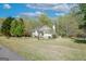 Beautiful home featuring mature trees, a well-manicured lawn, and charming front porch at 319 Honeysuckle Ter, Auburn, GA 30011