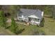 Inviting home featuring mature trees, a well-manicured lawn and front porch with rocking chairs at 319 Honeysuckle Ter, Auburn, GA 30011