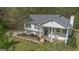 Charming home with a welcoming front porch framed by a lush canopy of trees and well-kept lawn at 319 Honeysuckle Ter, Auburn, GA 30011