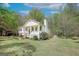 Attractive home featuring mature trees, a well-manicured lawn, and charming front porch at 319 Honeysuckle Ter, Auburn, GA 30011