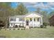Charming split-level home features a welcoming front porch, tidy landscaping, and a sunny facade at 319 Honeysuckle Ter, Auburn, GA 30011