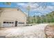 Spacious garage with dual doors and a long driveway leading to the home at 319 Honeysuckle Ter, Auburn, GA 30011