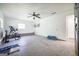 Bright garage with ceiling fan, ample space, and access door to the home at 319 Honeysuckle Ter, Auburn, GA 30011